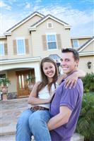 Couple in Love in Front Home (Focus on Woman) stock photo