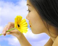 Woman Smelling Flower stock photo