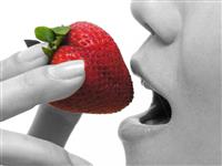 Woman Eating Strawberry stock photo