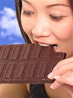 Woman Eating Chocolate stock photo