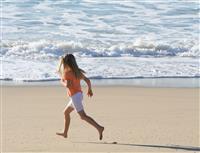 Girl Running on Beach stock photo