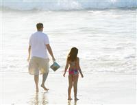 Father Playing with Daughter in Ocean stock photo