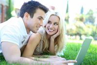 Couple in Park with Computer stock photo