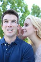 Man and woman Telling Secrets stock photo
