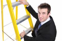 Handsome Business Man on Ladder stock photo