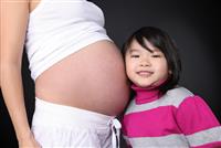 Girl Listening to Baby Pregnancy stock photo