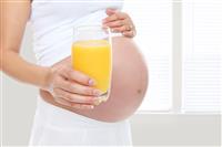 Pregnant woman drinking  juice  stock photo