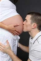 Husband Kissing Pregnant Wife stock photo