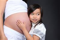 Girl Holding Baby Pregnancy stock photo