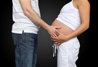 Man holding Pregnant Woman Stomach stock photo