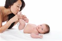 Mom Kissing Baby Toes stock photo