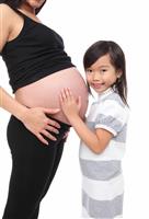 Girl Holding Baby Stomach stock photo
