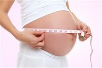 Pregnant woman measuring stomach  stock photo