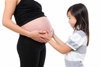 Girl Holding Baby Pregnancy stock photo