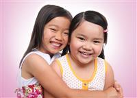Two asian young sisters hugging stock photo