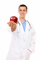 Doctor with Apple (Focus on Face) stock photo
