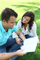 Couple Studying on Grass stock photo