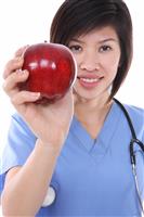 Pretty Asian Nurse with Apple stock photo