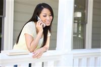 Pretty Asian Girl on Phone at Home stock photo