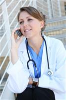 Beautiful Woman Nurse on phone stock photo