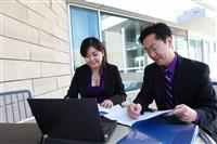 Chinese Man and Woman on Computer stock photo
