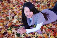 Asian Woman Laying in Leaves stock photo