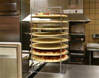 Pizzas in Rack  (Focus on pizzas) stock photo