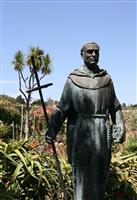 Priest Statue with Dramatic Shadows stock photo