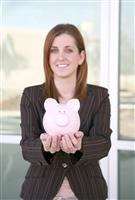 Business Woman and Bank (focus on piggy bank) stock photo