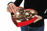Woman Eating Valentines Chocolate stock photo