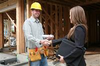 Woman Shaking Hands with COnstruction Man stock photo