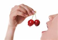 Woman Eating Cherries stock photo