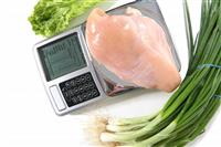 Raw Chicken on Scale stock photo