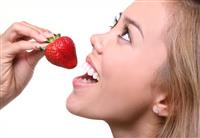 Woman Eating Strawberry stock photo