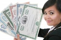 Woman Holding Stock Certificates stock photo
