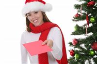 Woman Giving Christmas Card stock photo