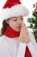 Girl Praying at Christmas stock photo