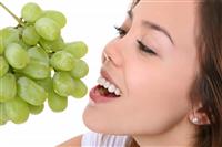 Woman Eating Grapes stock photo