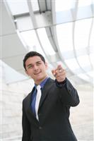Business Man Pointing with Office Building stock photo