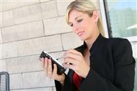 Pretty Blonde Business Woman and PDA stock photo