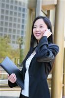 Asian Business Woman on Phone outside Office Building stock photo