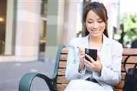 Asian Business Woman on Bench Outside Office stock photo