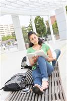Girl Student Reading on the School Campus stock photo