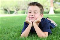 Boy Relaxing in Park stock photo