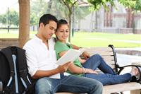 Attractive Teenage Students at College Reading stock photo