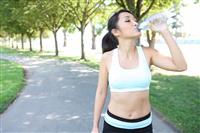 Pretty asian woman drinking water after Exercise stock photo