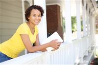Pretty African Woman on Home Porch stock photo