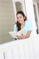 Pretty Girl Reading on Home Porch stock photo