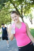 Jogger Drinking Water in Park stock photo
