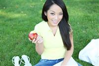 Pretty Girl Eating Apple and Reading stock photo